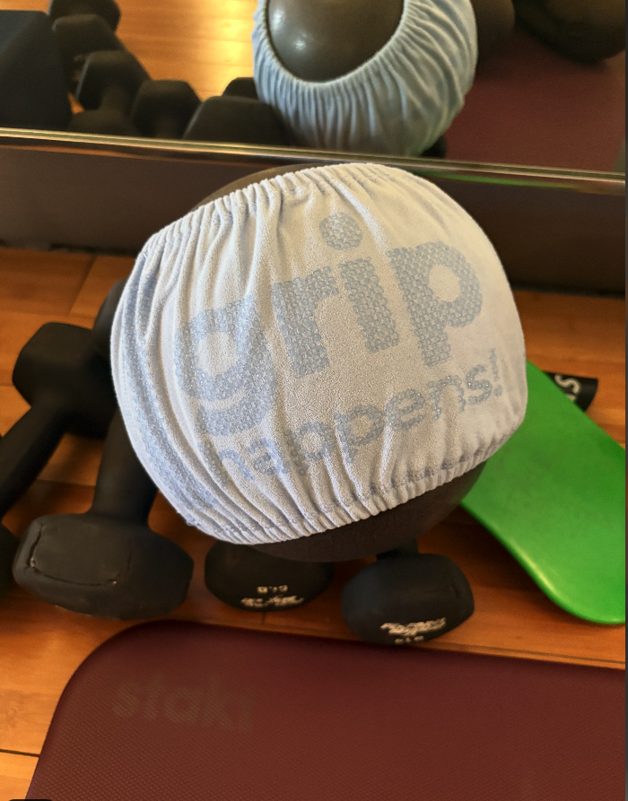 Grip Happens band on a Pilates ball in a studio